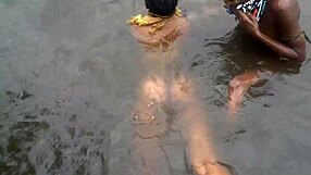 two lesbians bathe together in village river