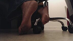 Foot boy watches dirty soles under desk