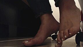 Foot boy watches dirty soles under desk