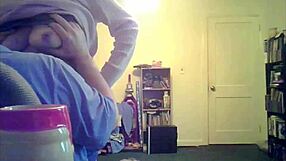 loris, the brunette milf, shows off her big tits in the living room setting