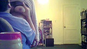 loris, the brunette milf, shows off her big tits in the living room setting