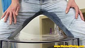 Babe in denim indulges in piss fetish by peeing through her pants