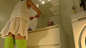 Brunette coed flashes panties in bathroom