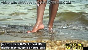 Giggles rubs feet on giant hot rock at beach