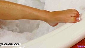 Delightful young brunette model enjoys a relaxing bath during photoshoot.