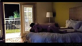 Young couple enjoys intimate time in motel with door open