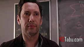 Tiny cheerleader helps teacher in classroom setting.