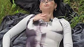 She is smoking on the grass and decides to show her boobs under the sun