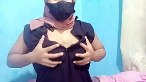 Hijab-clad Indonesian girl masturbates to orgasm with dildo.