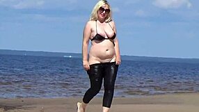 Big leather ass strolls beach in heels and naked