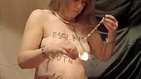 the female slave performs a self-bondage session with wax and candles