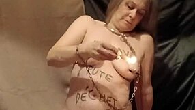 the female slave performs a self-bondage session with wax and candles