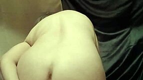 the female slave performs a self-bondage session with wax and candles