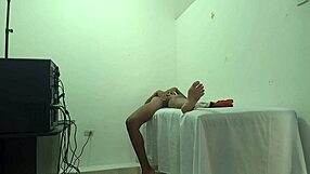 a beautiful brunette massage therapist waits for a client to arrive in her office she moans while making movements showing her buttocks and breasts