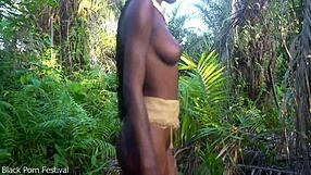 Dark Skin African Girl Dances In Raffia Outdoors