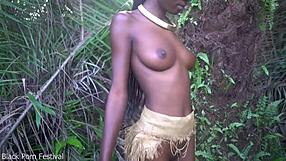 Dark Skin African Girl Dances In Raffia Outdoors
