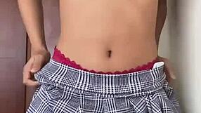 Petite in skirt dances, then fucks her pussy with fingers