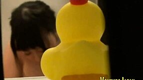 Asian babe fingers her sudsy shaved pussy outdoors in public shower