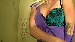 sexy tattooed blonde stevie shae masturbates sucking big cock through bathroom gloryhole cumshot facial