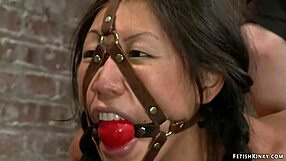 Asian babe wrapped tight in plastic bondage hung for kinky punishment