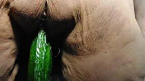 granny stuffs cucumber deep in her hairy wet pussy