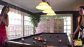 Lesbian babes fuck each other hard with dildo on pool table desk fingering tits.