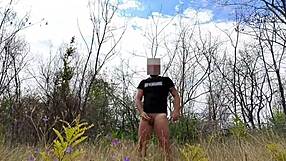 Handsome muscular bodybuilder strokes monster cock naked in public park