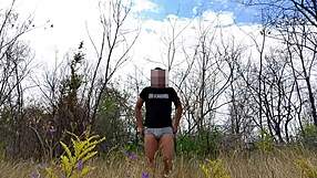 Handsome muscular bodybuilder strokes monster cock naked in public park