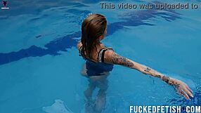 ashlee rose glides underwater in silver dress her natural tits teasing softly