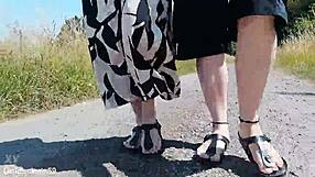 german mature walks barefoot in birkenstocks through public outdoor nature