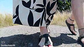 german mature walks barefoot in birkenstocks through public outdoor nature