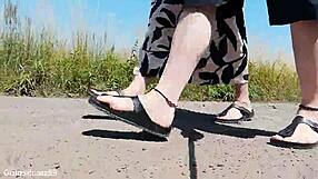 german mature walks barefoot in birkenstocks through public outdoor nature