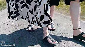 german mature walks barefoot in birkenstocks through public outdoor nature