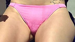 rubbing creamy sun lotion over her huge tits while flashing panties public beach