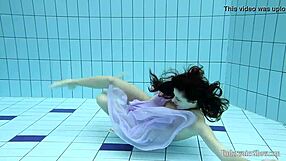 Aneta flaunts big tits in purple dress while bathing underwater in pool