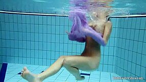 Aneta flaunts big tits in purple dress while bathing underwater in pool