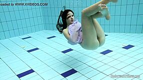 Aneta flaunts big tits in purple dress while bathing underwater in pool