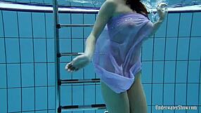 Aneta flaunts big tits in purple dress while bathing underwater in pool