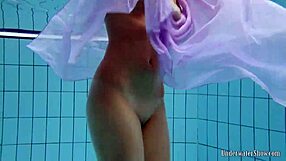 Aneta flaunts big tits in purple dress while bathing underwater in pool