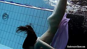 Aneta flaunts big tits in purple dress while bathing underwater in pool