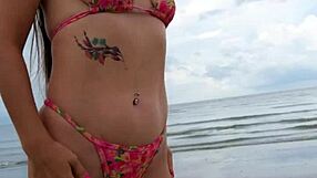 Cute petite brunette walks beach posing in sexy revealing bikini outdoors