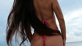 Cute petite brunette walks beach posing in sexy revealing bikini outdoors