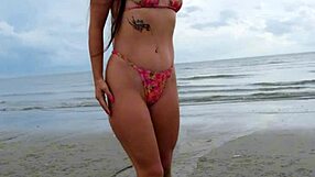 Cute petite brunette walks beach posing in sexy revealing bikini outdoors