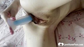 the cute blonde babe grabs her new dildo and teases her shaved pussy with long skinny legs