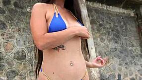 Pretty brunette in blue bikini dances flashes fingers beach publicly