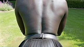 of book and boobs in leather skirt outdoors