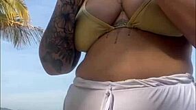 Shorts cling tight to beach girl's big flashing pussy