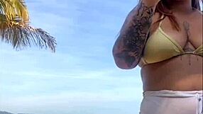 Shorts cling tight to beach girl's big flashing pussy