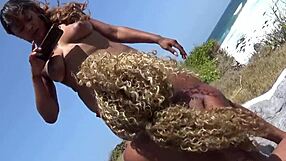 Pornstar Porsha Carrera straps on huge toy and roughly fucks Nina Rivera outdoors on beach