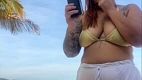 Shorts cling tight to beach girl's big flashing pussy